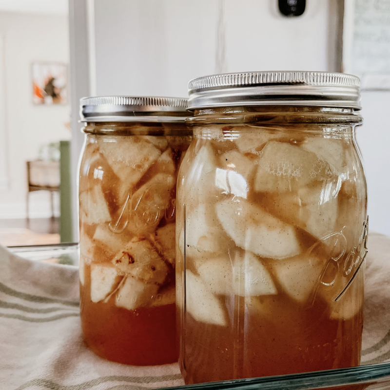 Two cans of apple preserves