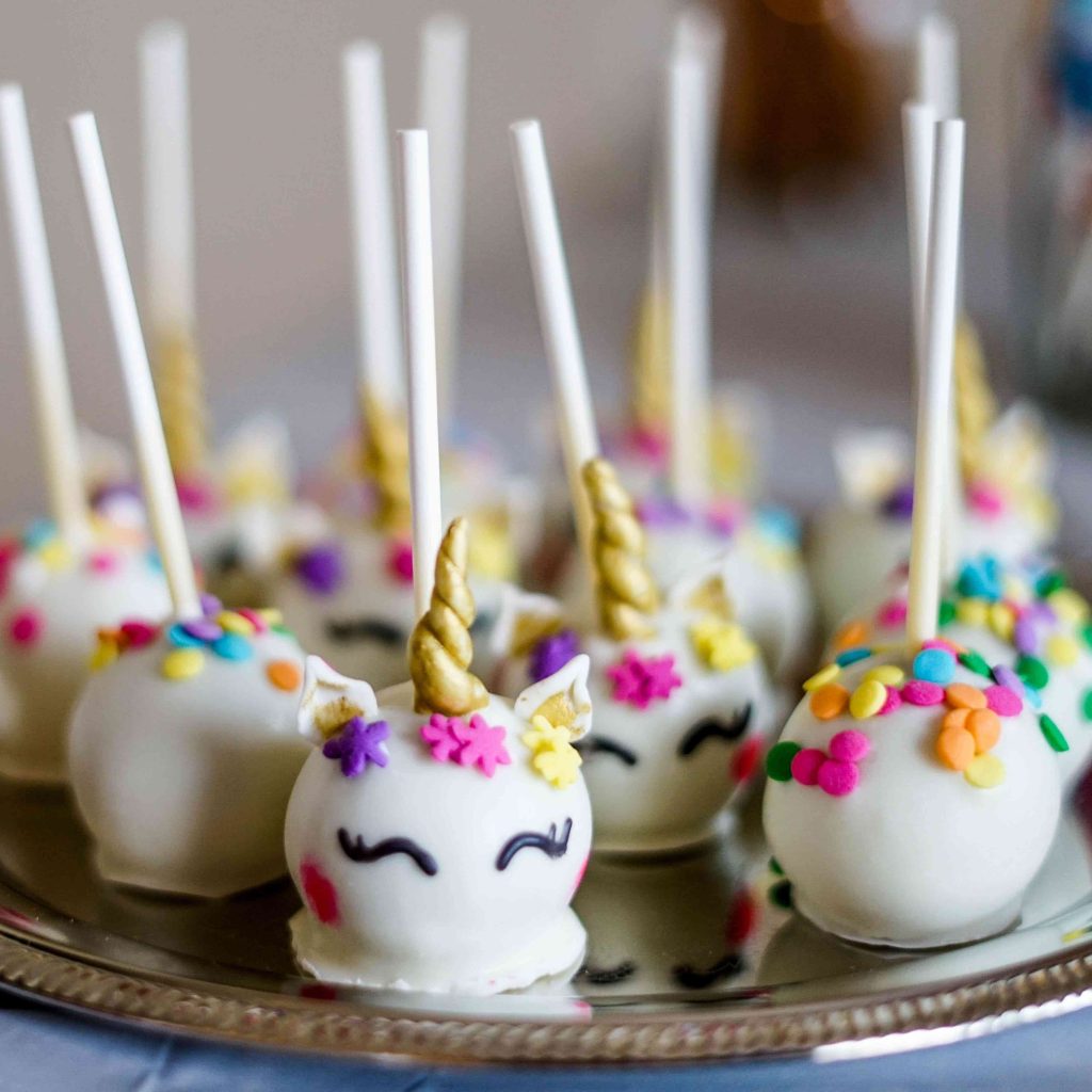 A plate of Halloween unicorn cake pops
