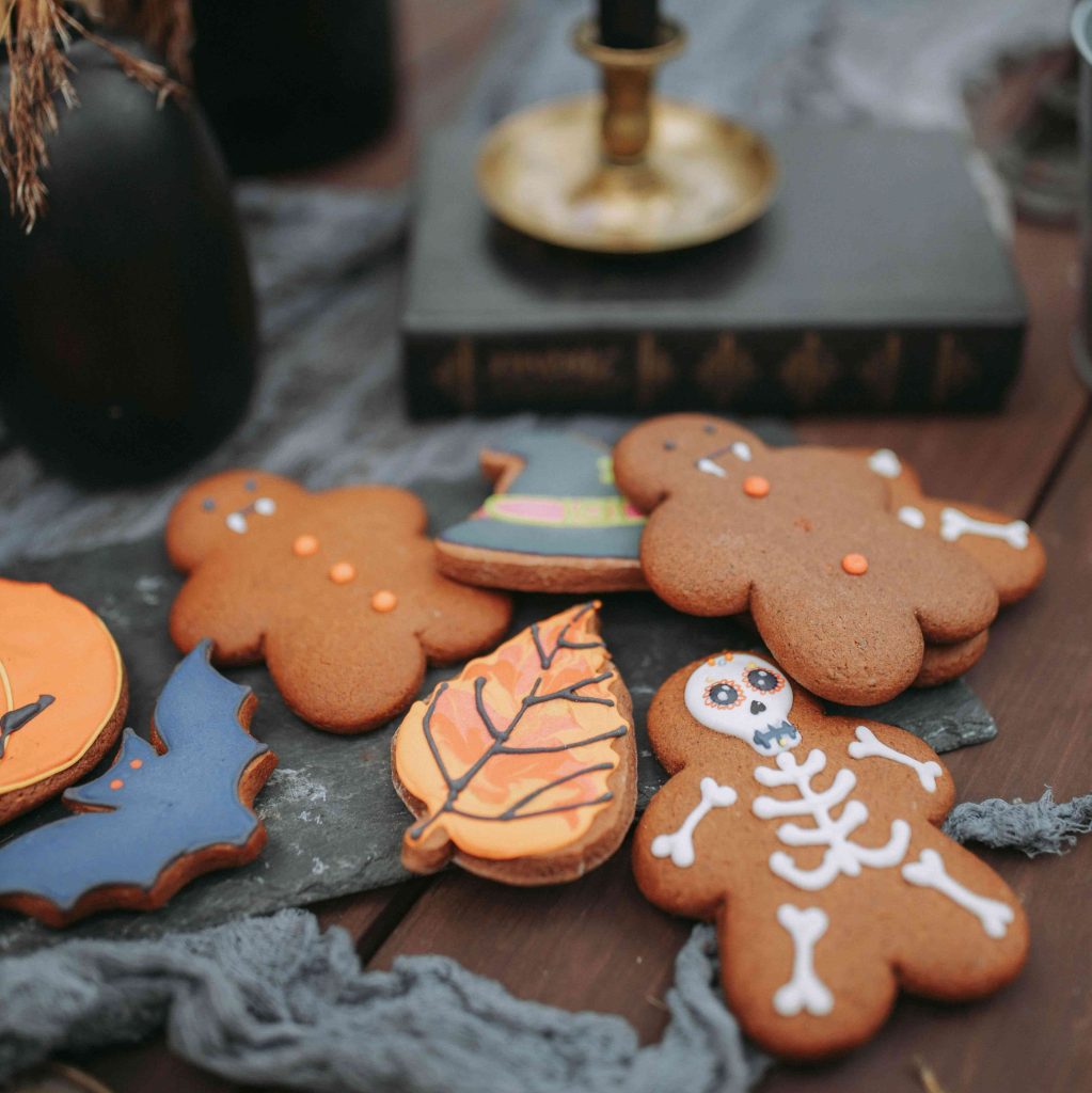 Ginger Halloween cookies decorated as skeletons, bats and vampires