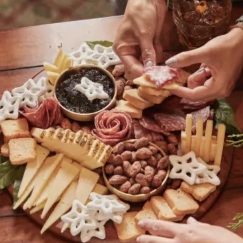 Holiday charcuterie board with cheese, nuts and jam