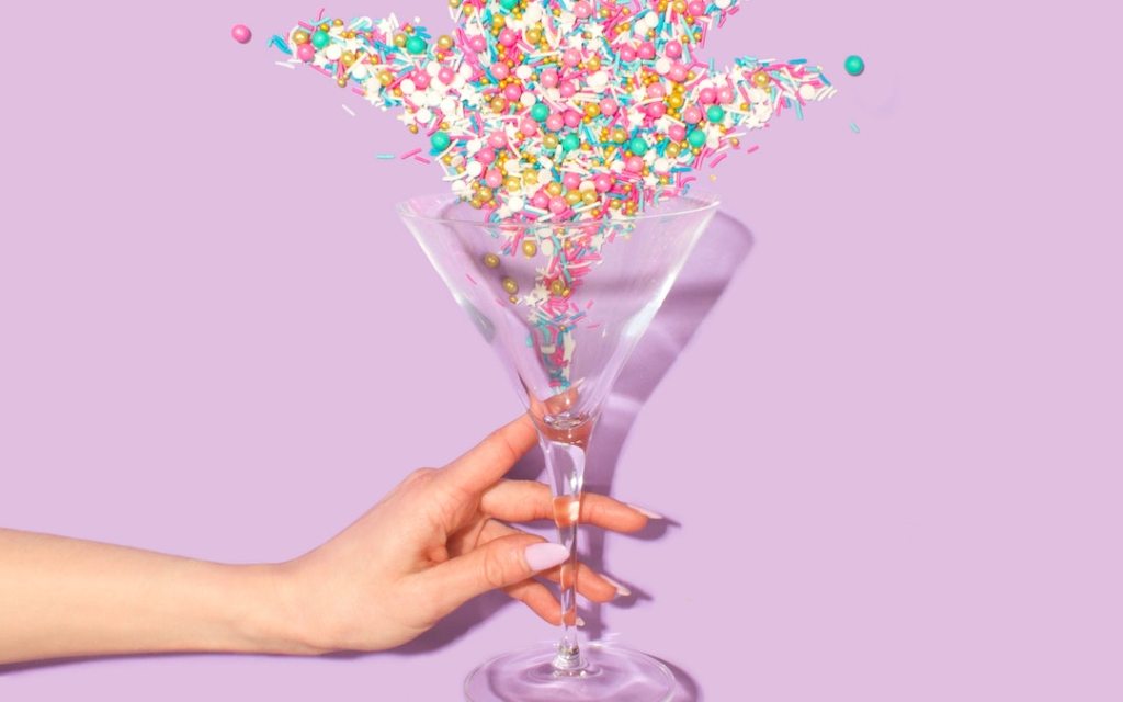 Martini glass filled with decoration candies and sprinkles