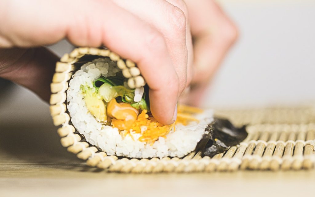 Person rolling sushi