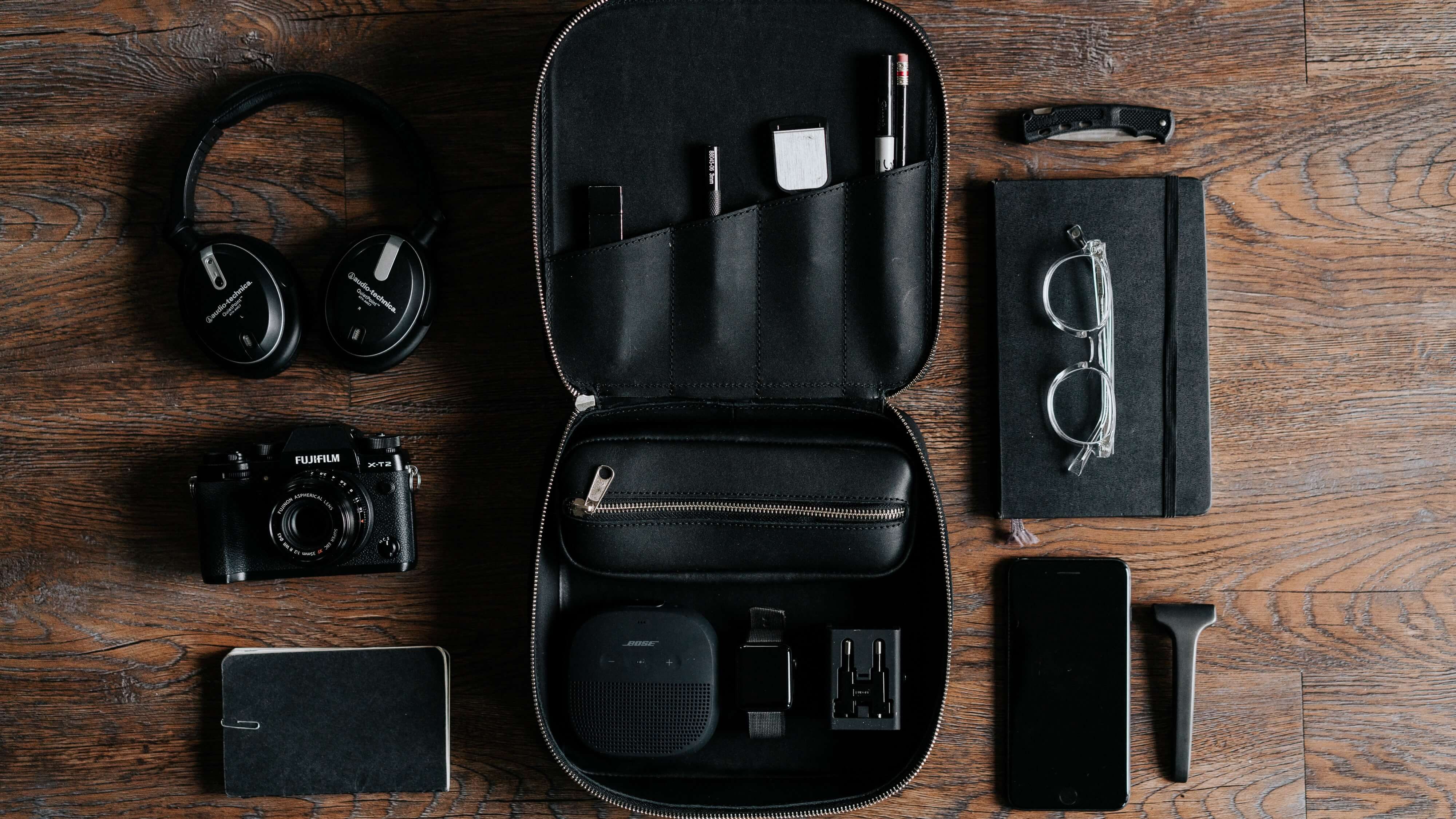 Swag travel kit that consists of the organizer, travel gadgets, notebooks and headphones 