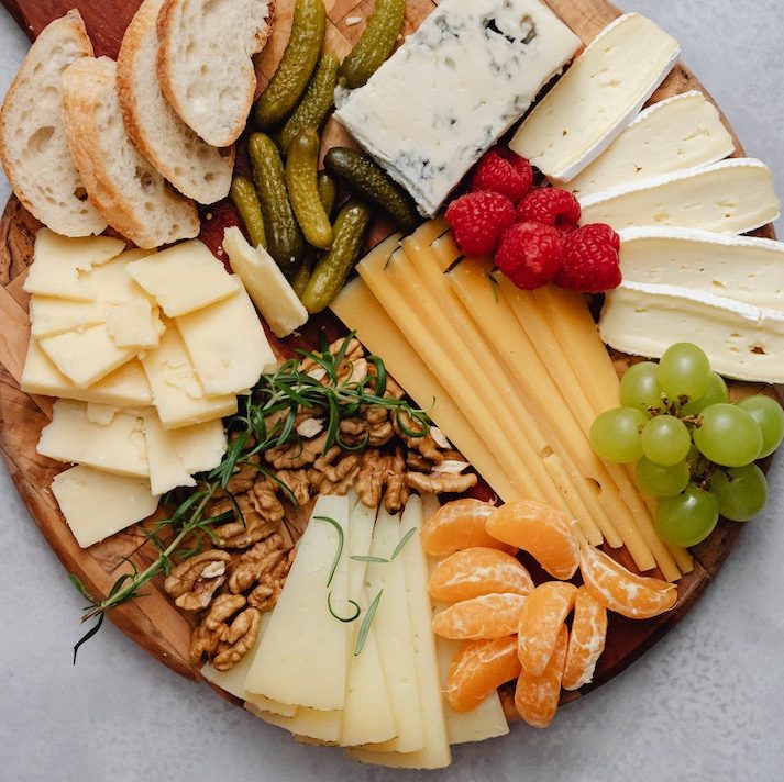 Charcuterie board with cheese, crackers and fruits